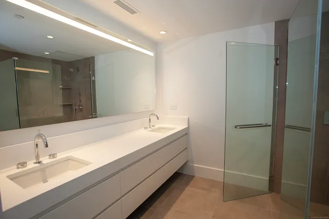 a bathroom with a shower and a sink