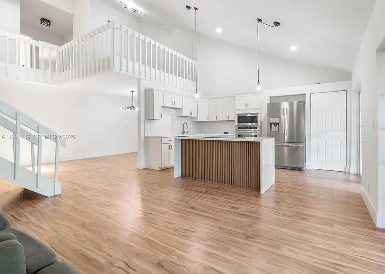 6850 Northwest 2nd Avenue, Unit 34 Boca Raton, FL 33487 - Photo 2 of 23 a large kitchen with cabinets and wooden floor