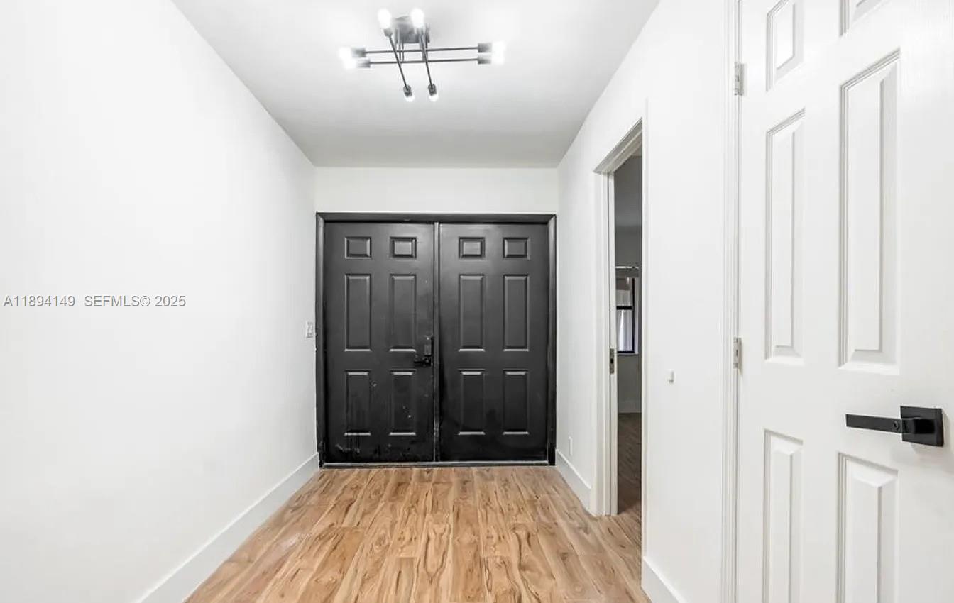 6850 Northwest 2nd Avenue, Unit 34 Boca Raton, FL 33487 - Photo 22 of 23 a view of a hallway with wooden floor