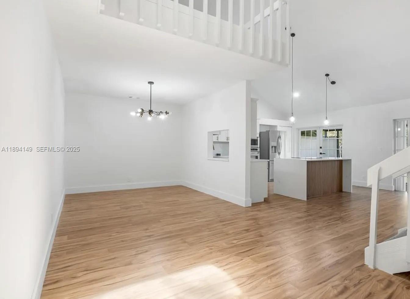 6850 Northwest 2nd Avenue, Unit 34 Boca Raton, FL 33487 - Photo 6 of 23 a view of a kitchen with refrigerator and wooden floor