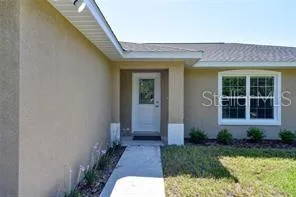 a view of a brick house with a small yard