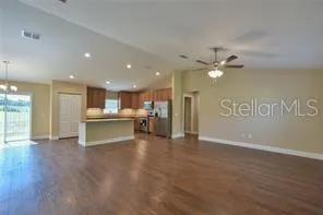 a view of an empty room with a kitchen