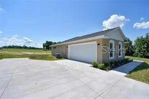 a view of a house with a yard and a garage