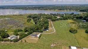 a view of a water pond with green field