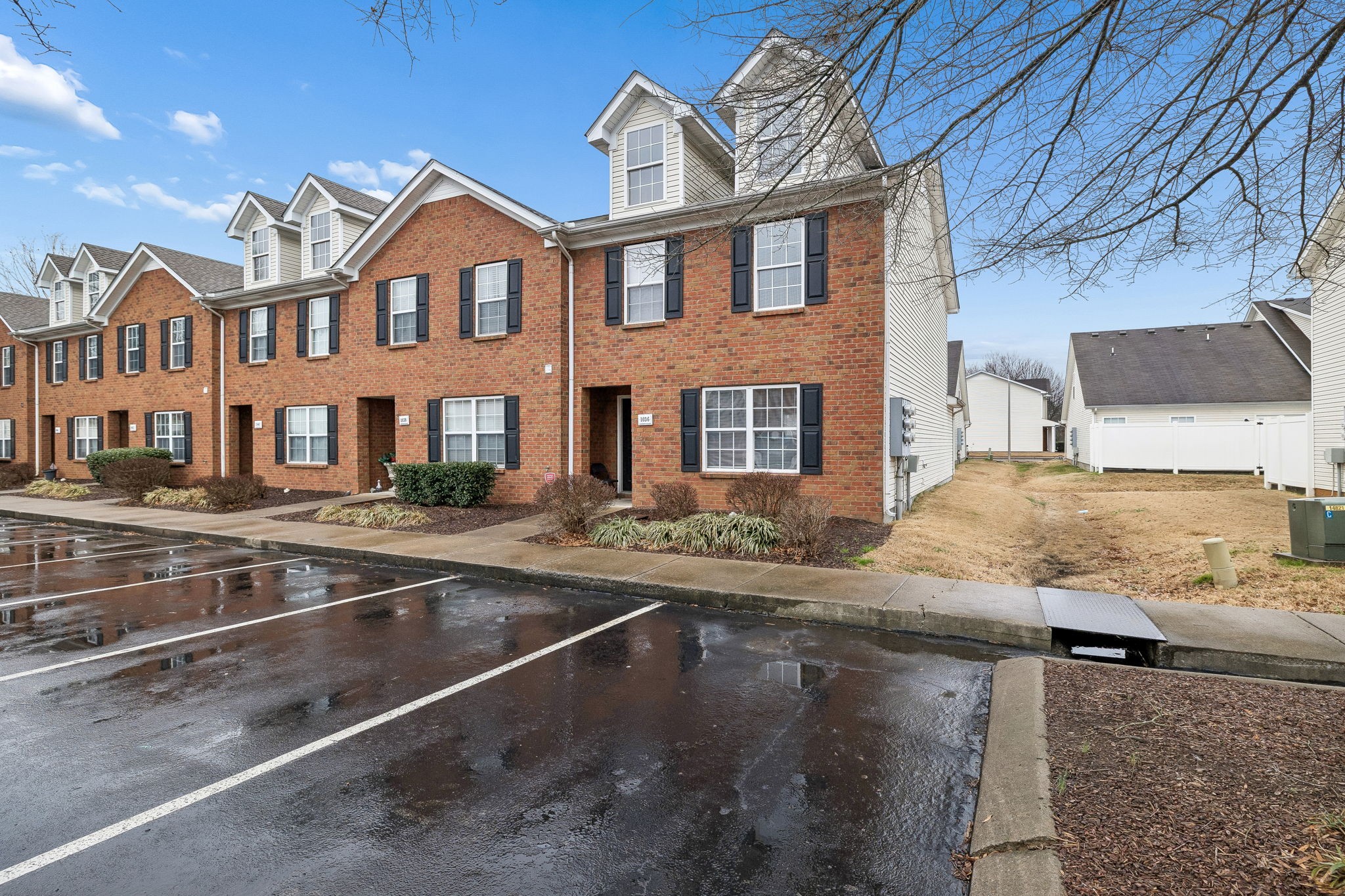1036 Wolves Den Place Murfreesboro, TN 37128 - Photo 4 of 15 a view of a brick house with many windows