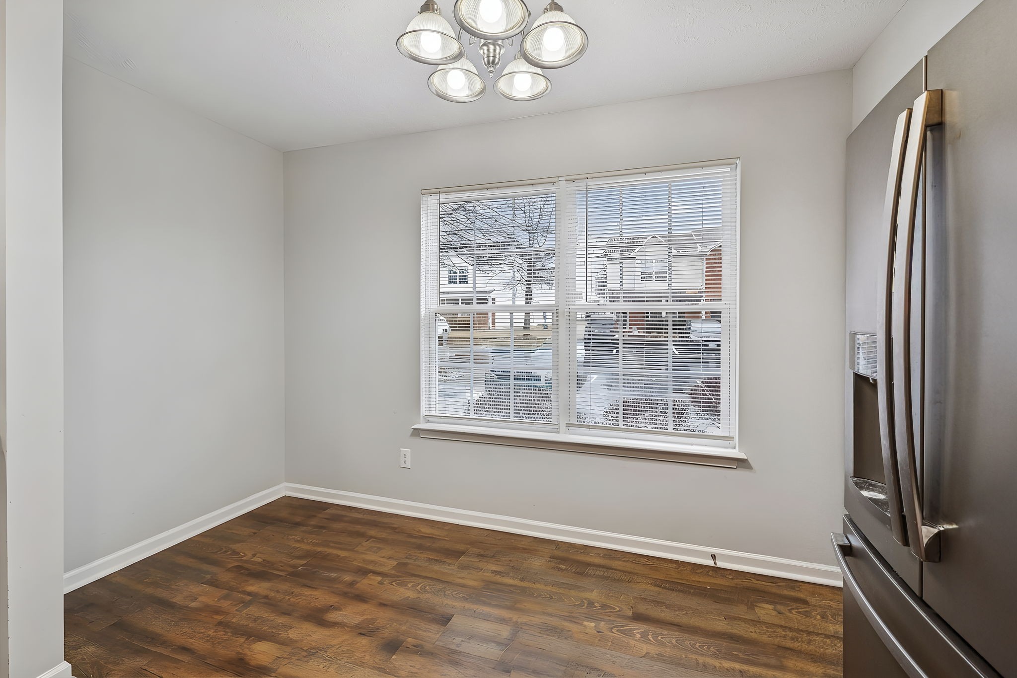 1036 Wolves Den Place Murfreesboro, TN 37128 - Photo 8 of 15 a view of an empty room with wooden floor and a window