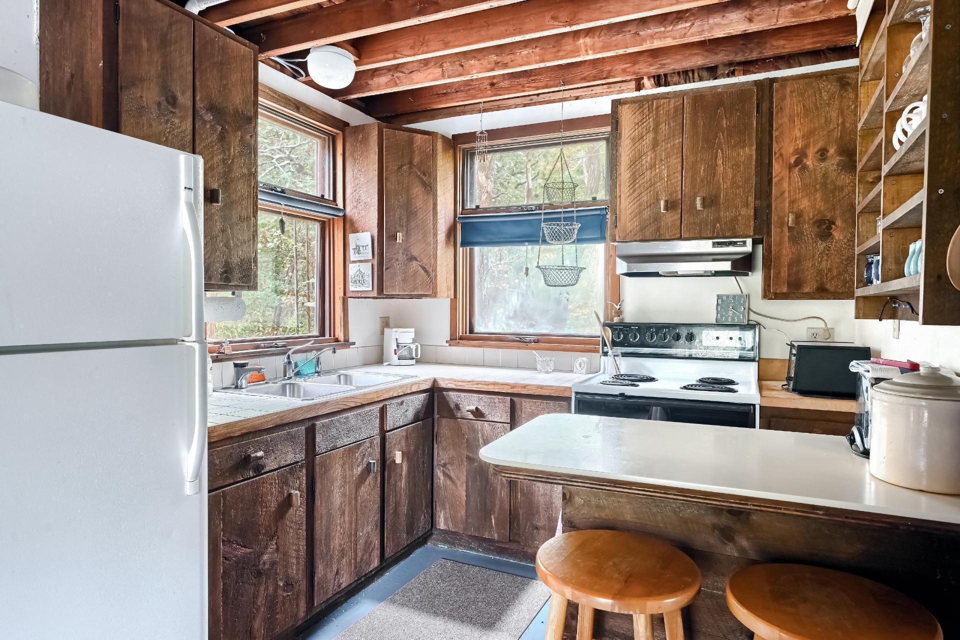 500 Gull Pond Road Wellfleet, MA 02667 - Photo 15 of 62 a kitchen with a stove a sink and a refrigerator