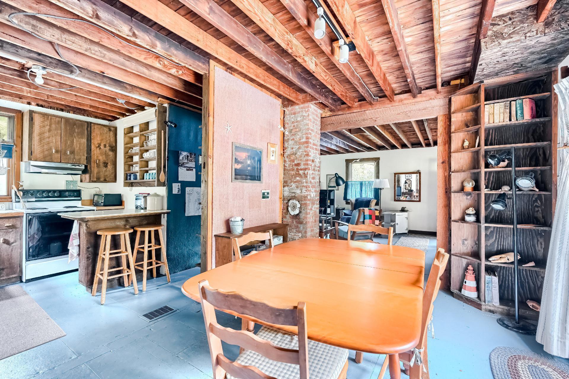 500 Gull Pond Road Wellfleet, MA 02667 - Photo 19 of 62 a dining table with chairs and wooden floor