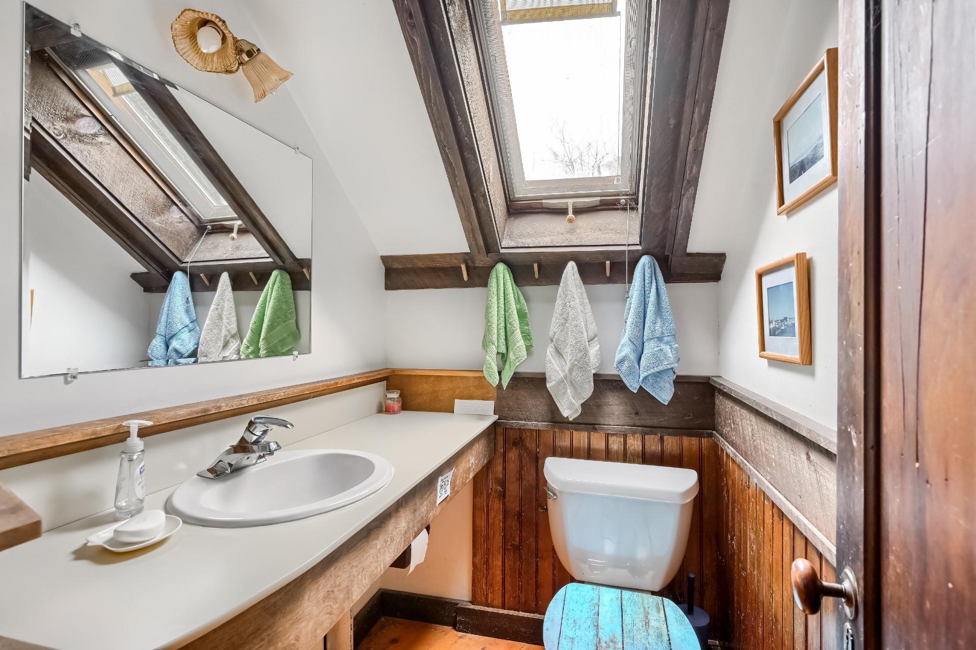 500 Gull Pond Road Wellfleet, MA 02667 - Photo 32 of 62 a bathroom with a sink a toilet and a mirror