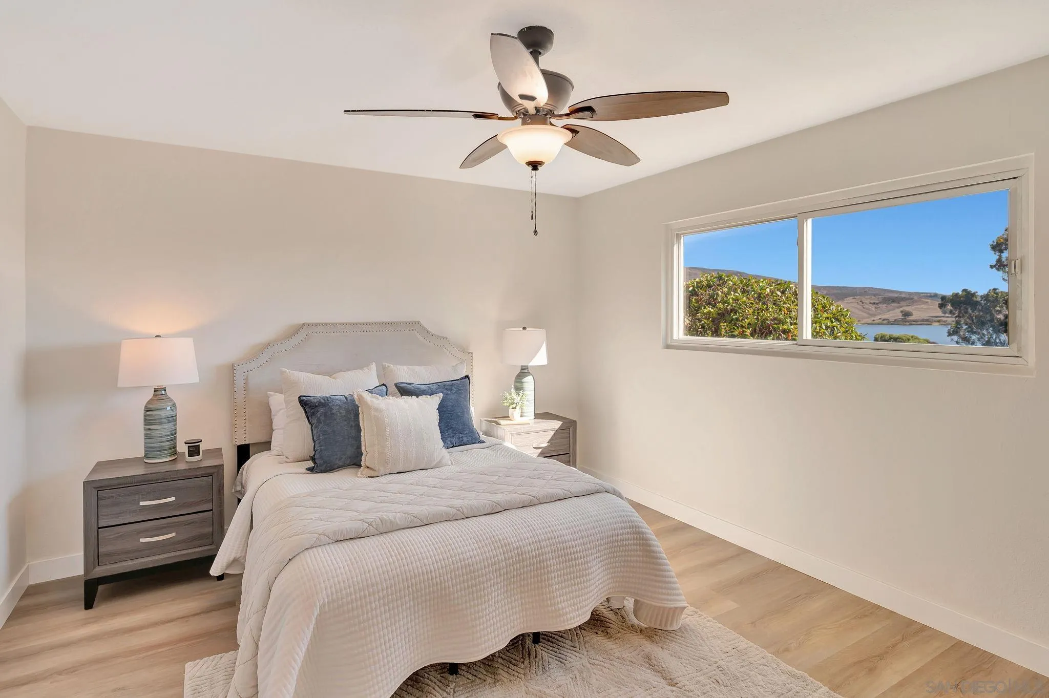9421 Avenida Acero Spring Valley, CA 91977 - Photo 18 of 47 a bedroom with a bed and a chandelier