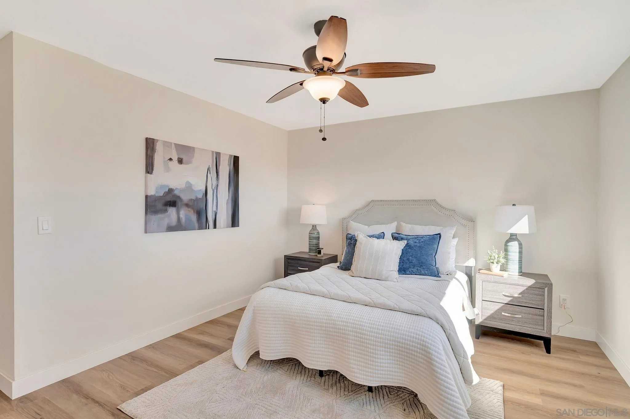 9421 Avenida Acero Spring Valley, CA 91977 - Photo 19 of 47 a bedroom with a bed and a chandelier