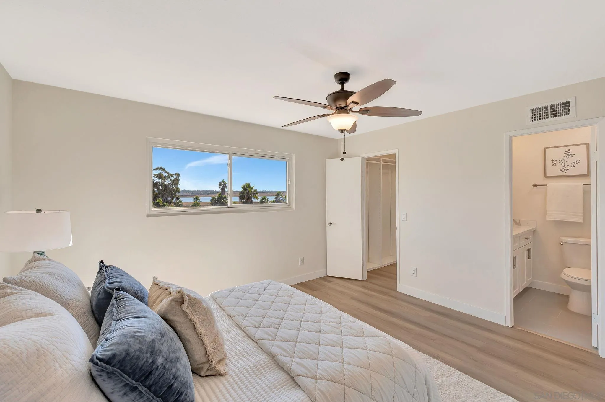 9421 Avenida Acero Spring Valley, CA 91977 - Photo 20 of 47 a bedroom with a large bed and a chandelier