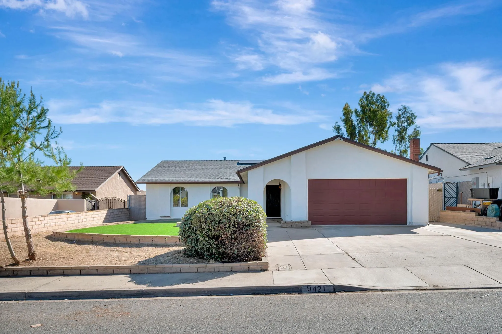 9421 Avenida Acero Spring Valley, CA 91977 - Photo 2 of 47 a front view of a house with a garden and entryway