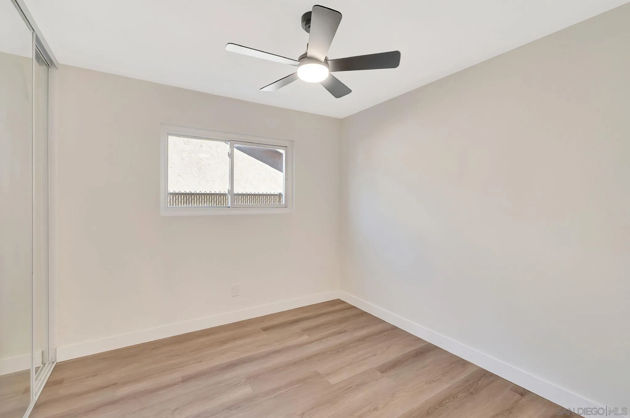 9421 Avenida Acero Spring Valley, CA 91977 - Photo 22 of 47 an empty room with wooden floor and windows