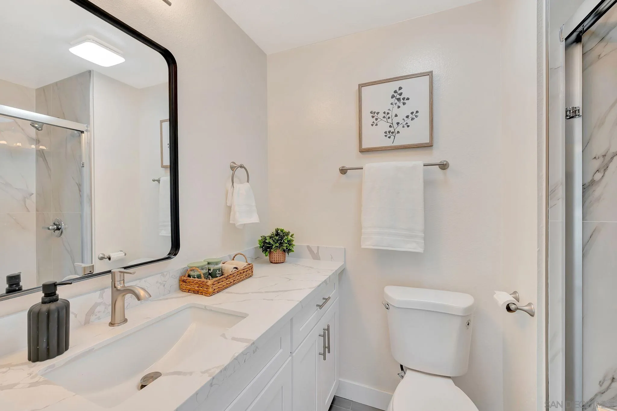 9421 Avenida Acero Spring Valley, CA 91977 - Photo 29 of 47 a bathroom with a granite countertop sink mirror vanity and toilet