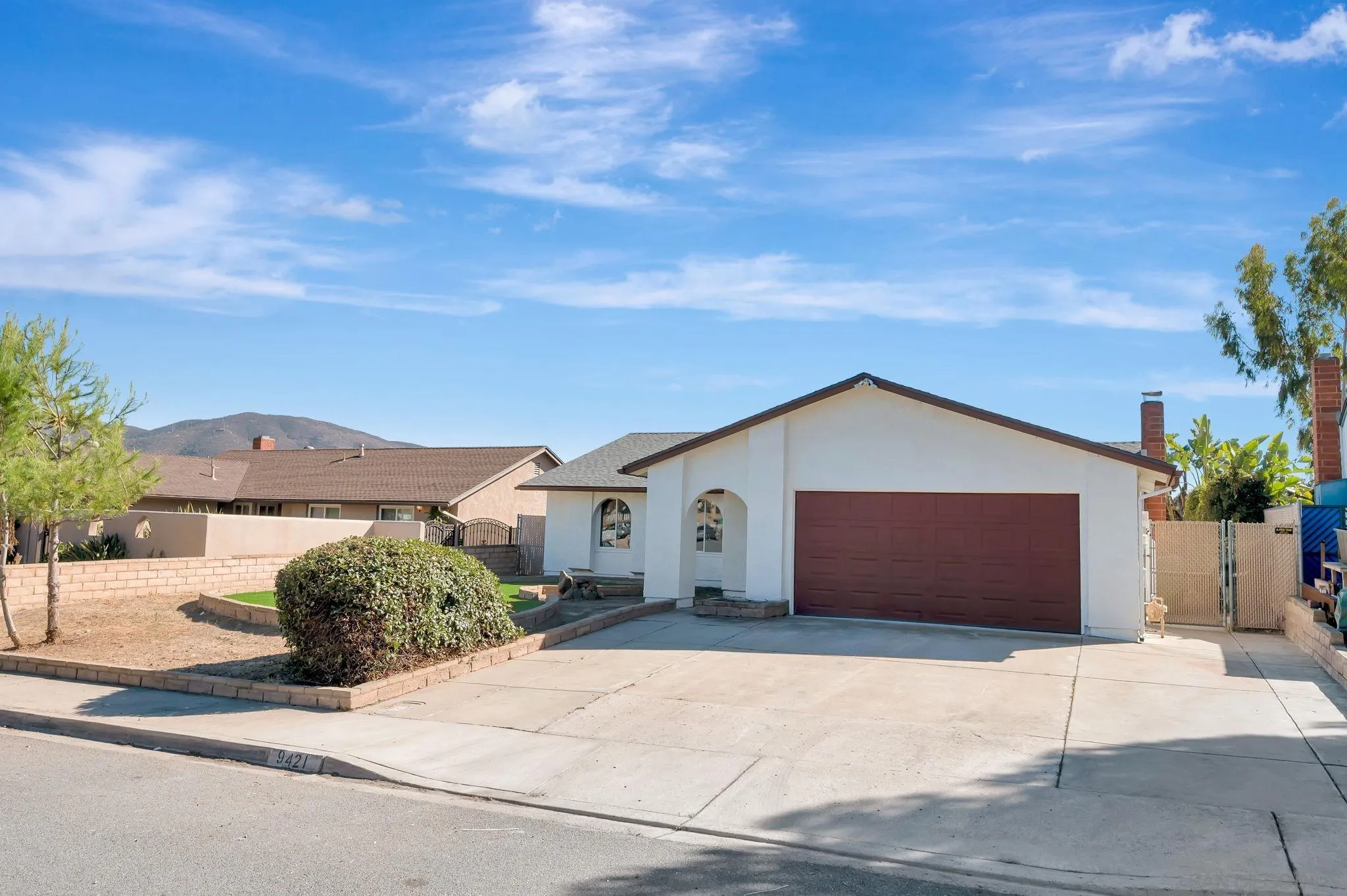 9421 Avenida Acero Spring Valley, CA 91977 - Photo 3 of 47 a front view of a house with a garden