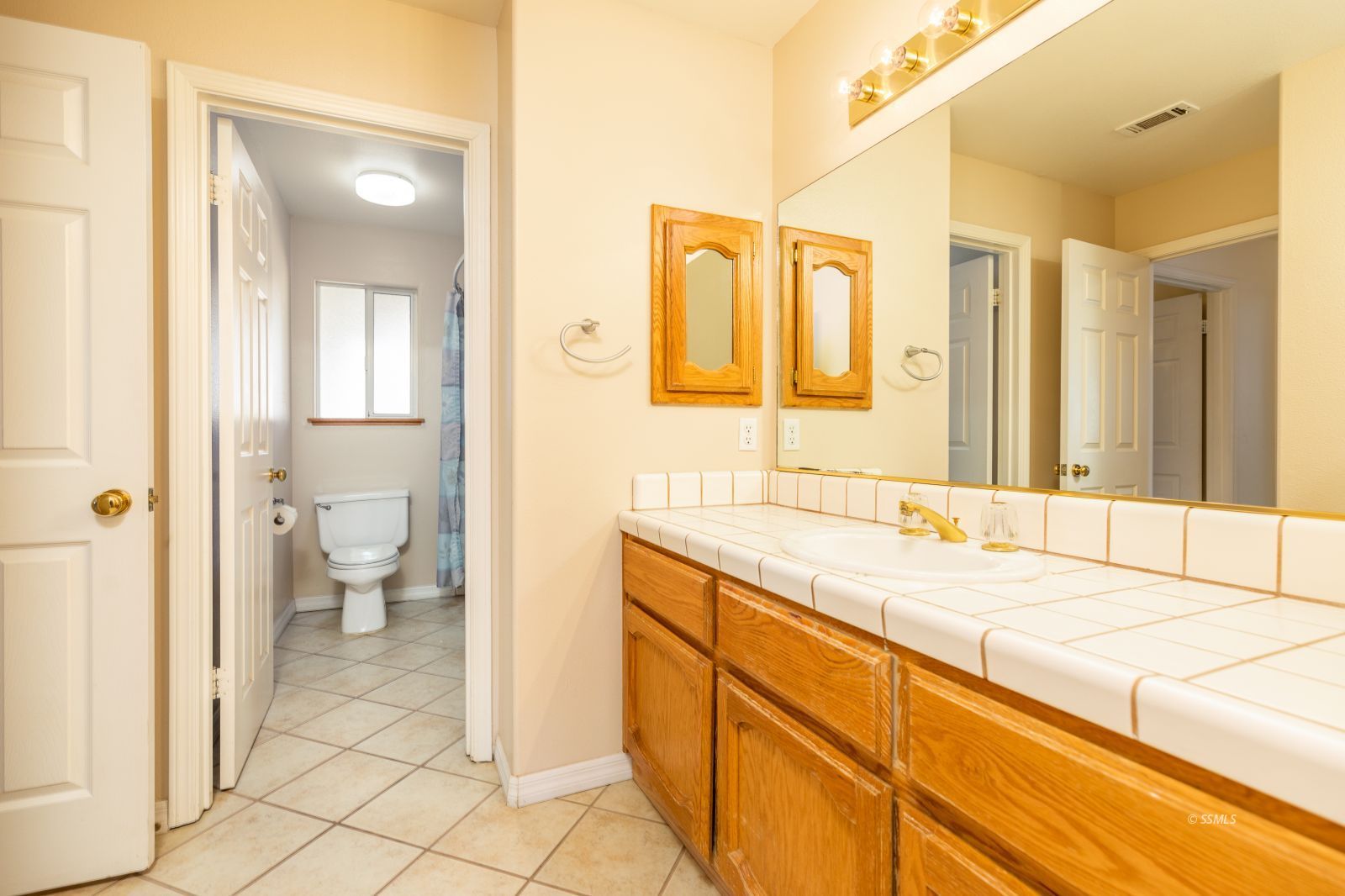 1225 Andrea Court Ridgecrest, CA 93555 - Photo 32 of 46 a spacious bathroom with a granite countertop sink and a mirror