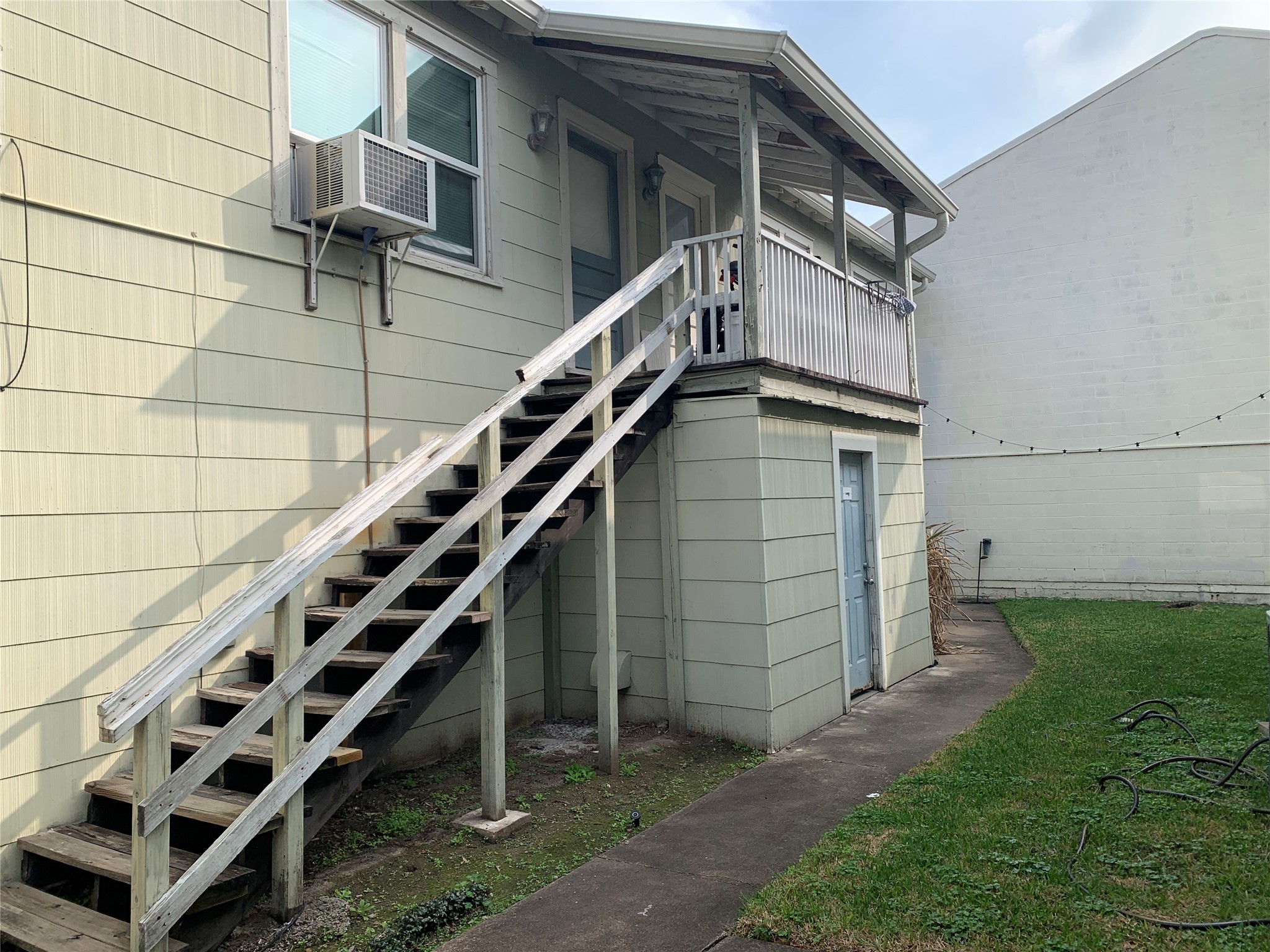 307 Avondale Street, Unit 1 5 Houston, TX 77006 - Photo 3 of 20 a house with wooden stairs and a small yard