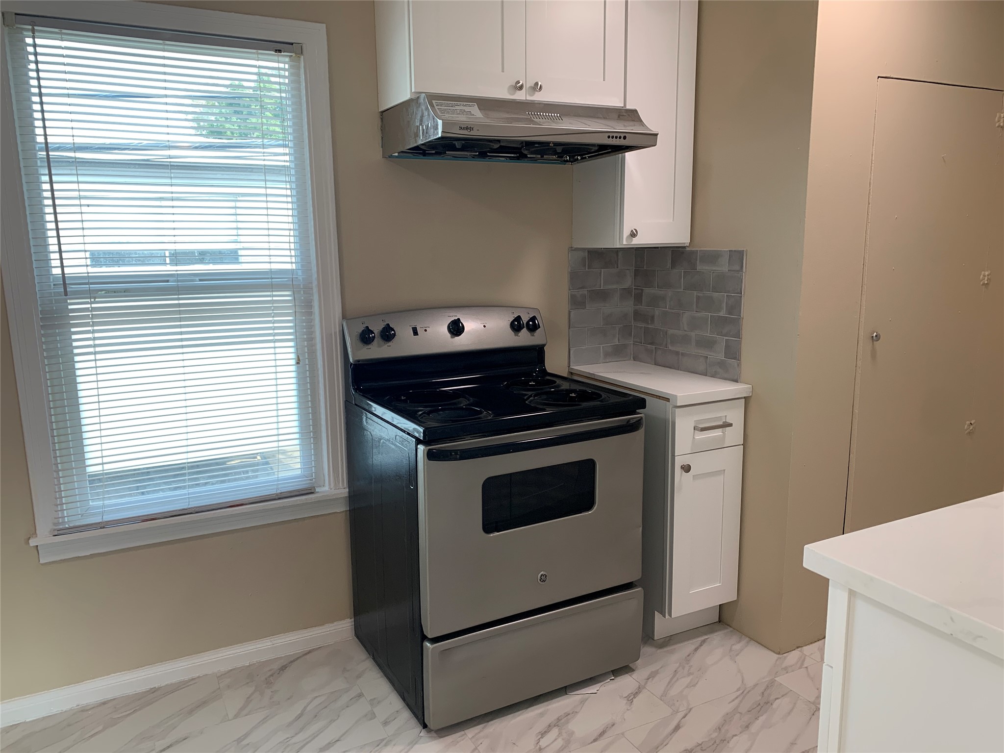 307 Avondale Street, Unit 1 5 Houston, TX 77006 - Photo 9 of 20 a kitchen with granite countertop cabinets stainless steel appliances and a window
