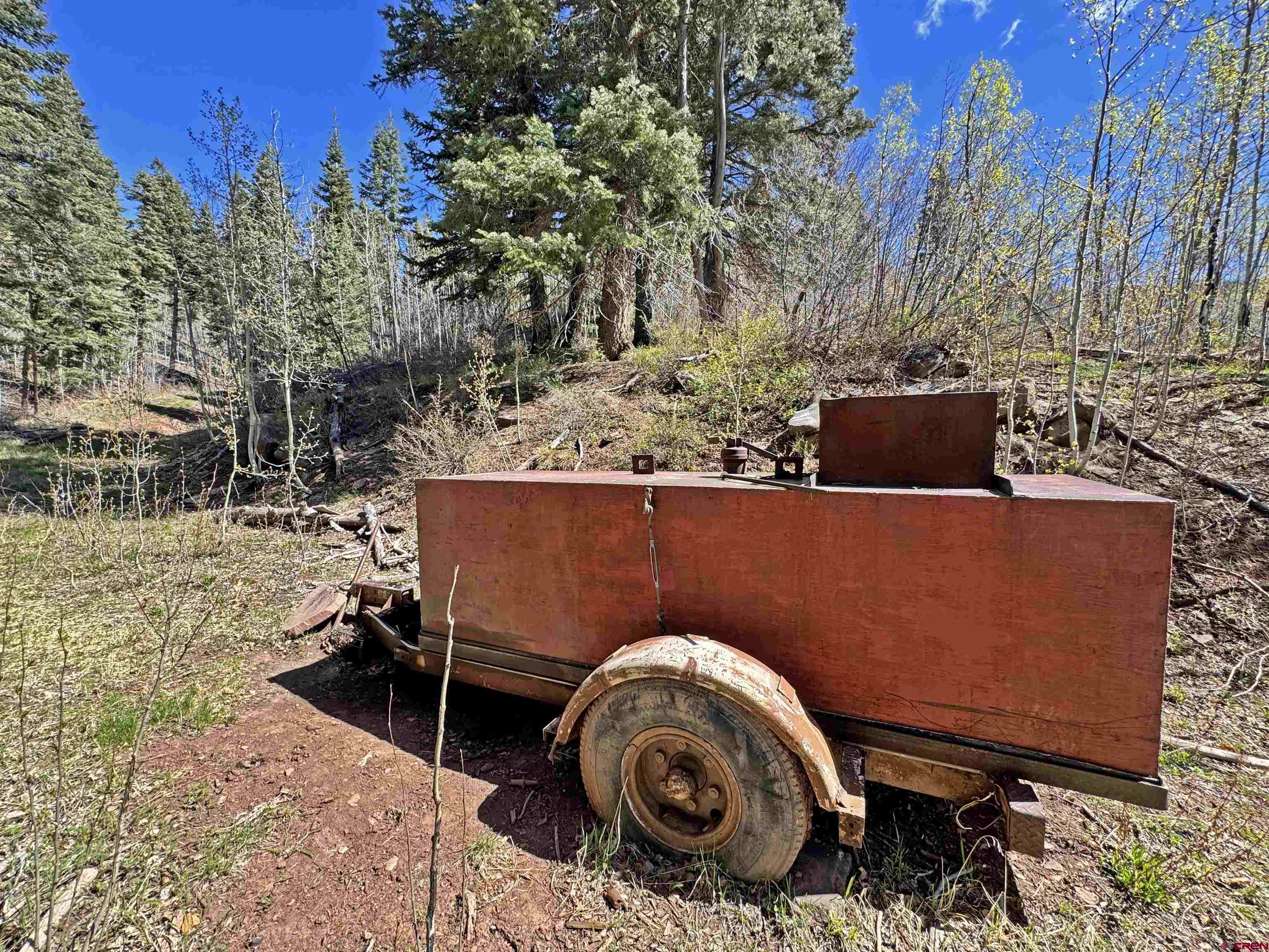 1515 County Road 243 Durango, CO 81301 - Photo 3 of 43 a backyard of a house with barbeque oven and trees