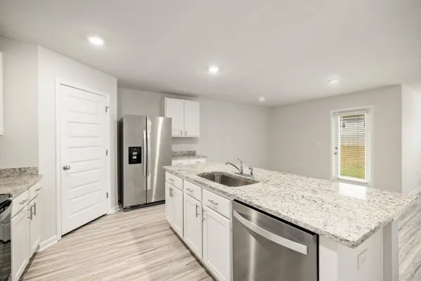 a kitchen with stainless steel appliances granite countertop a sink and cabinets