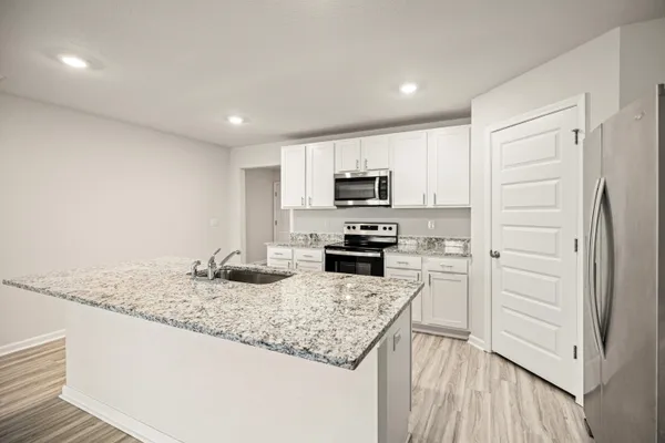 a kitchen with granite countertop cabinets and steel stainless steel appliances