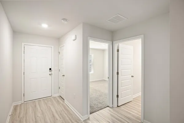 a view of hallway with wooden floor