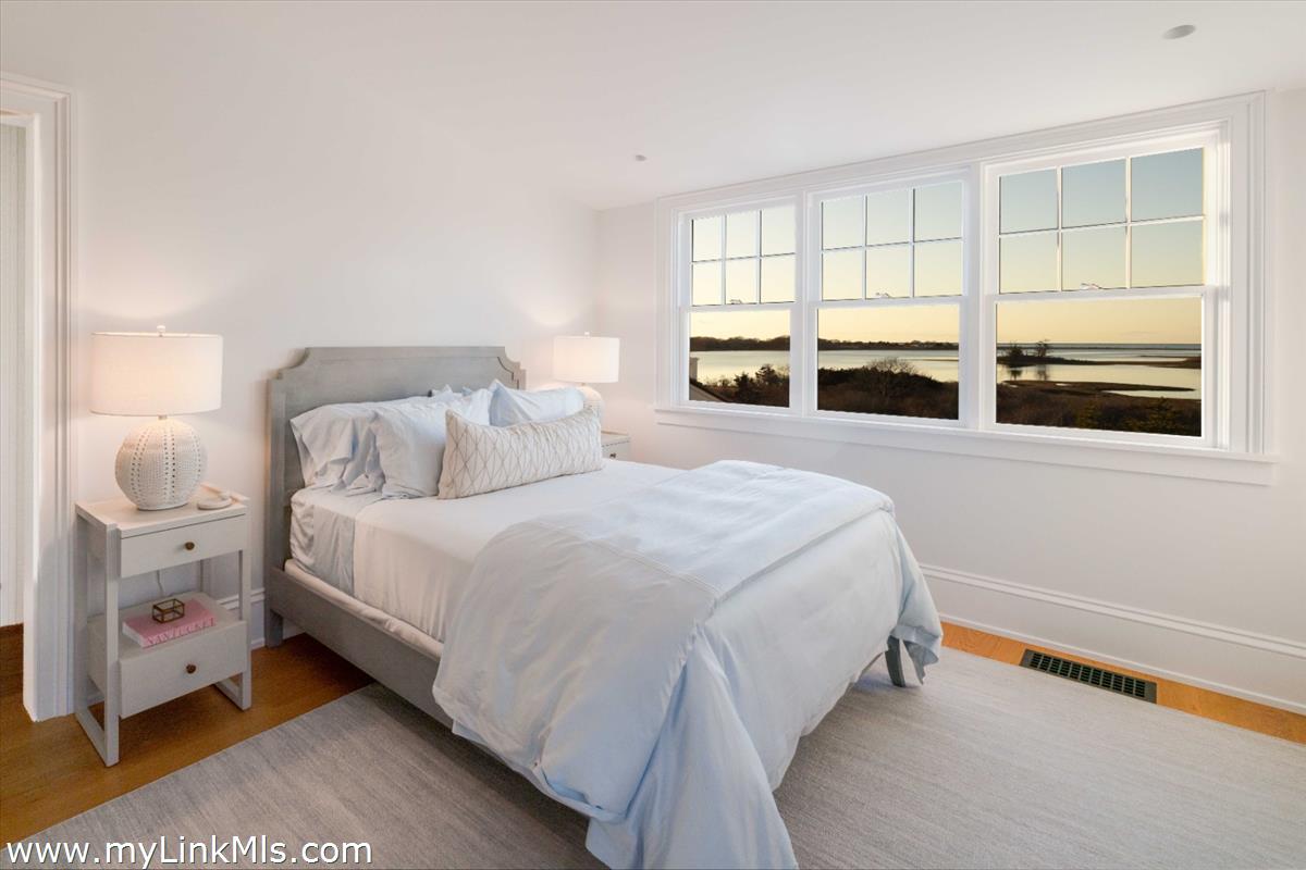 256 Polpis Road Nantucket, MA 02554 - Photo 23 of 30 a bedroom with a bed and a large window