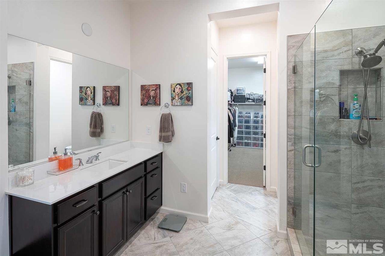 9404 Hawkshead Road Reno, NV 89521 - Photo 11 of 22 a bathroom with a sink vanity granite tub shower and mirror