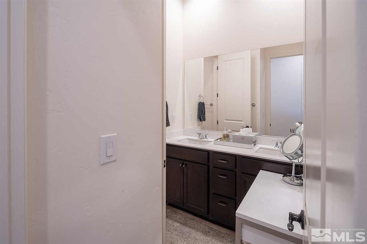 9404 Hawkshead Road Reno, NV 89521 - Photo 13 of 22 a bathroom with a sink and mirror