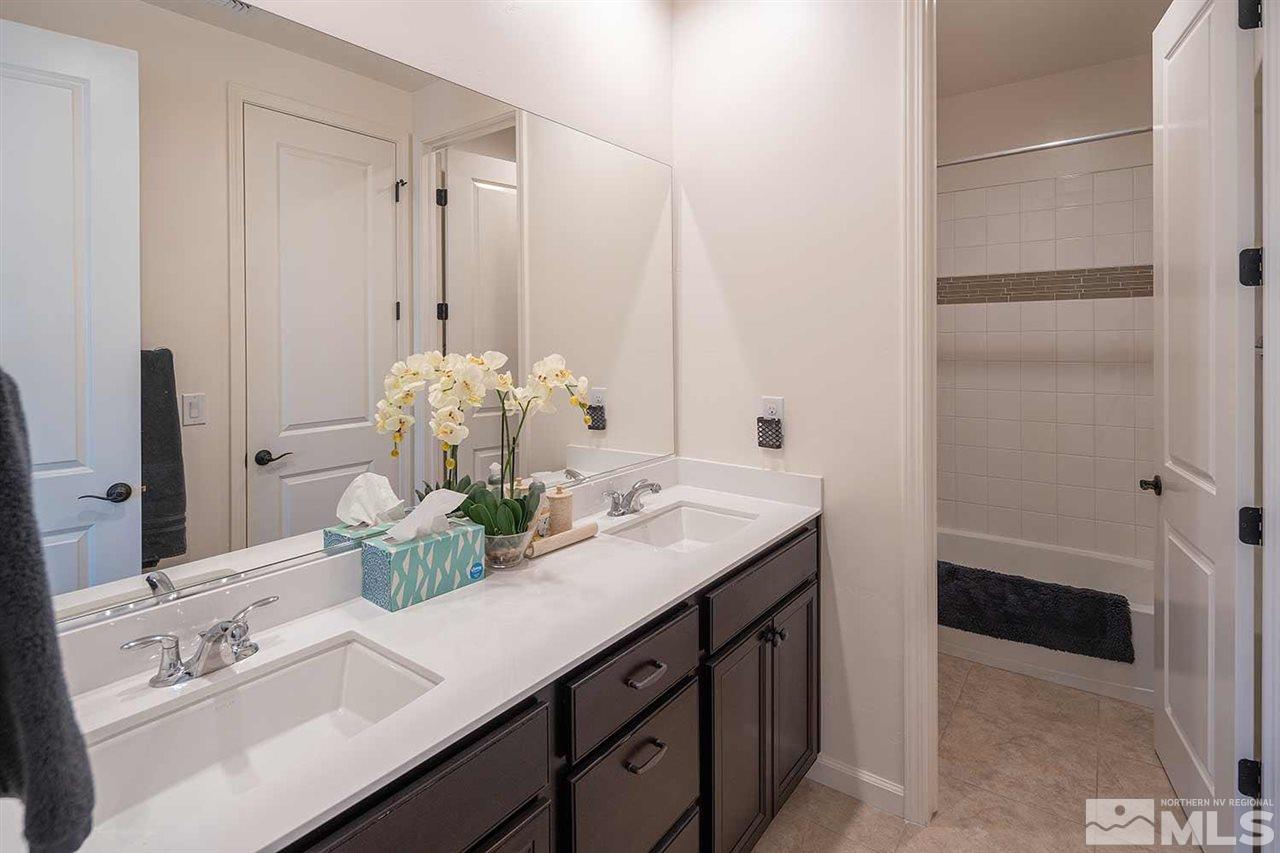 9404 Hawkshead Road Reno, NV 89521 - Photo 17 of 22 a bathroom with a sink and a mirror