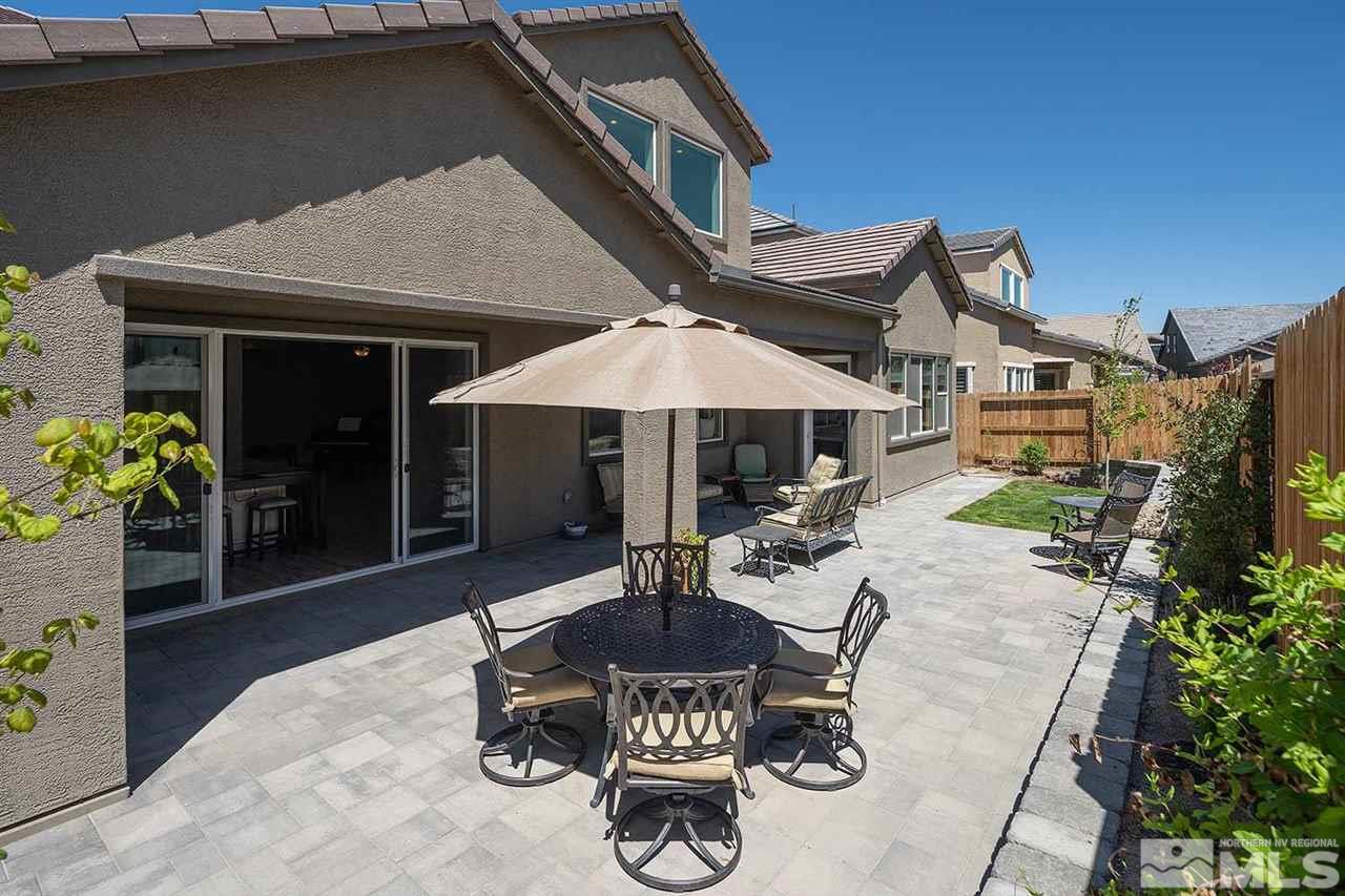 9404 Hawkshead Road Reno, NV 89521 - Photo 20 of 22 a patio with a table and chairs under an umbrella