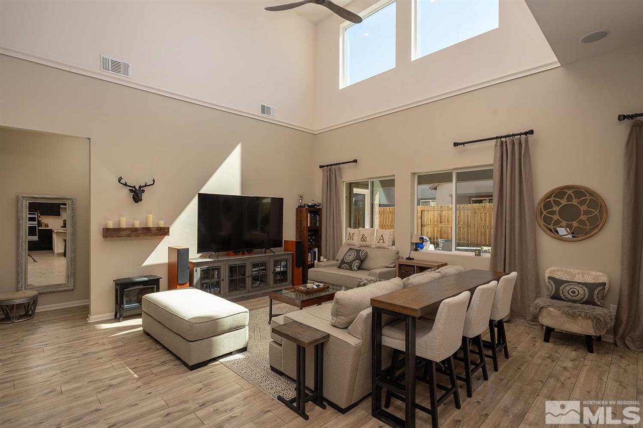 9404 Hawkshead Road Reno, NV 89521 - Photo 2 of 22 a living room with furniture and a flat screen tv