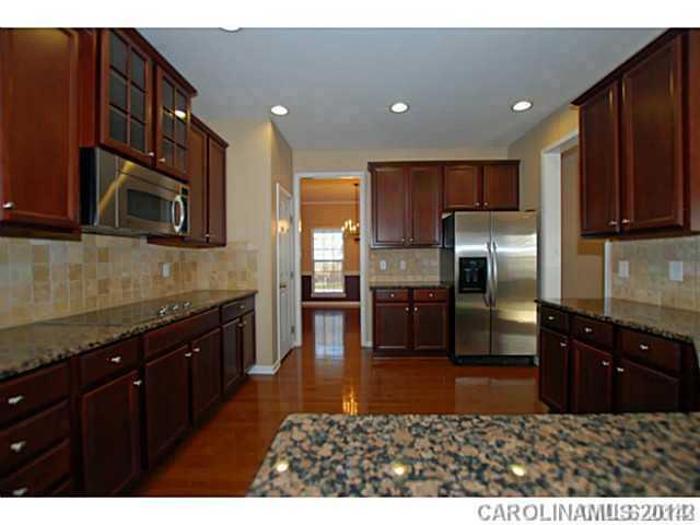 7155 Meyer Road Fort Mill, SC 29715 - Photo 2 of 14 a kitchen with stainless steel appliances granite countertop a refrigerator a stove a sink and a microwave