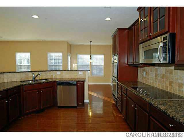 7155 Meyer Road Fort Mill, SC 29715 - Photo 6 of 14 a kitchen with stainless steel appliances granite countertop a sink a stove and cabinets