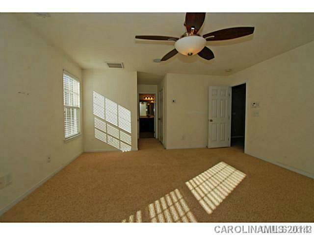 7155 Meyer Road Fort Mill, SC 29715 - Photo 9 of 14 a view of an empty room with a ceiling fan and window