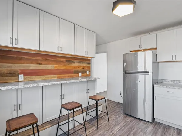 a kitchen with cabinets and stainless steel appliances