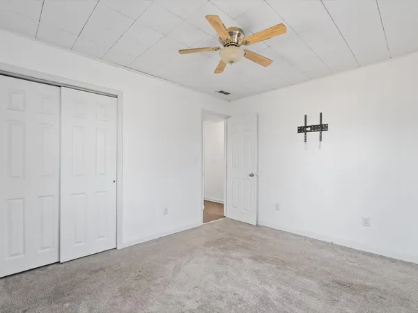 an empty room with a ceiling fan