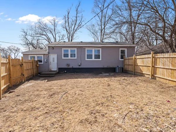 a view of a house with a yard covered in snow