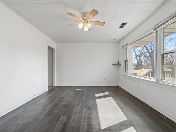 wooden floor in an empty room with a window