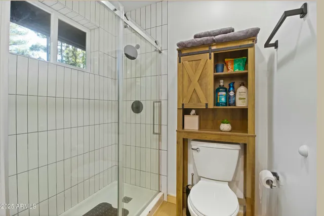 a living room with furniture and a ceiling fan