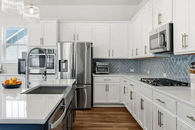 a kitchen with a table chairs and windows
