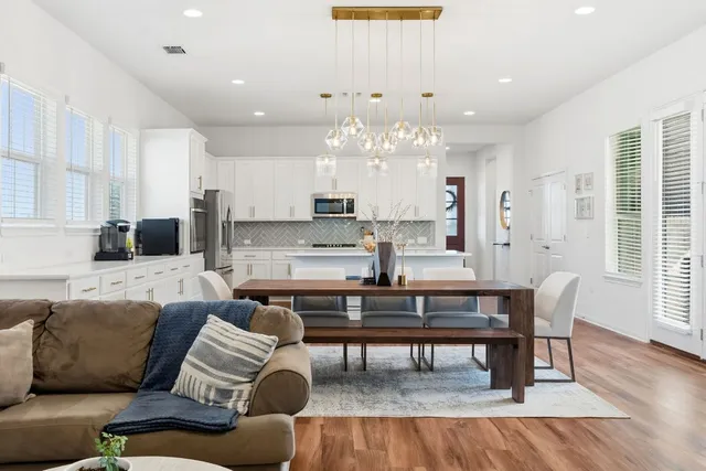 a living room with furniture and a view of kitchen