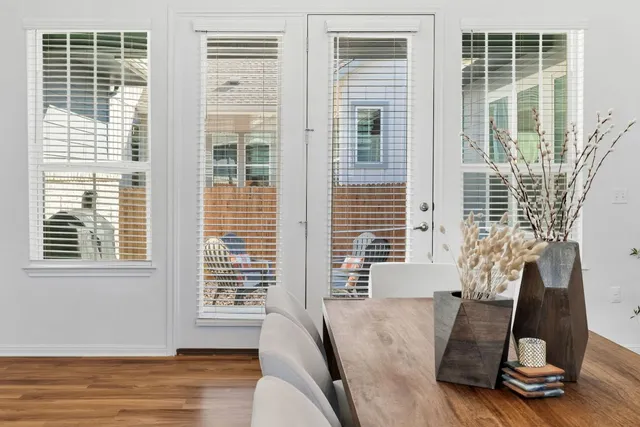 a living room with furniture and a dining table