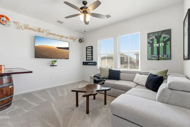 a view of a workspace with furniture and a window