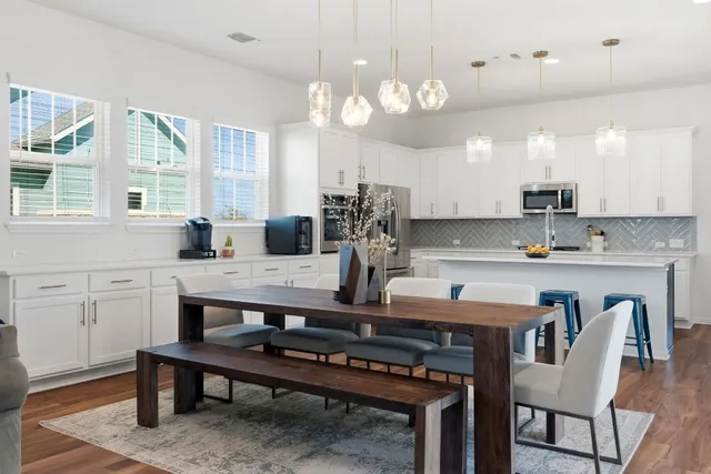 a living room with furniture and kitchen view