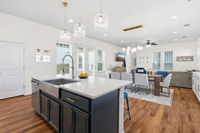 a kitchen with cabinets table and chairs