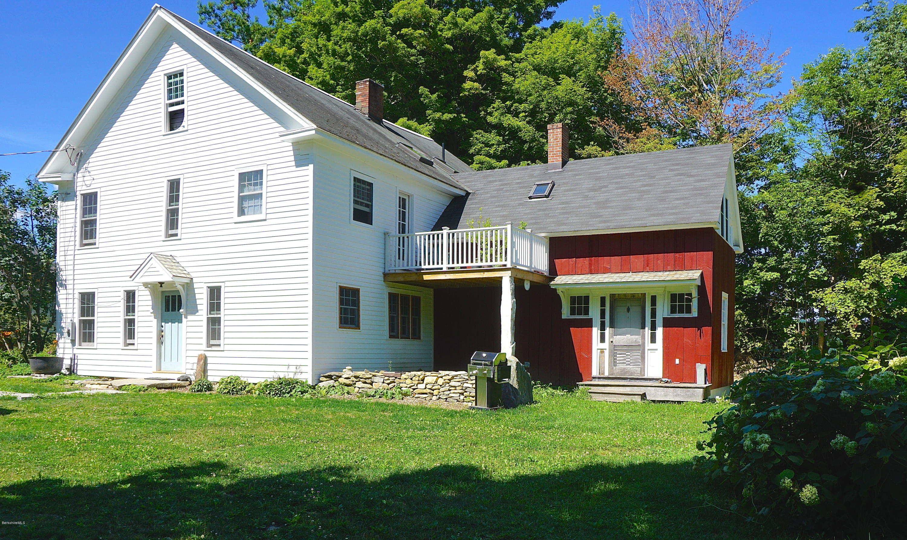 519 Main Road Monterey, MA 01245 - Photo 1 of 28 a front view of a house with a yard and garage