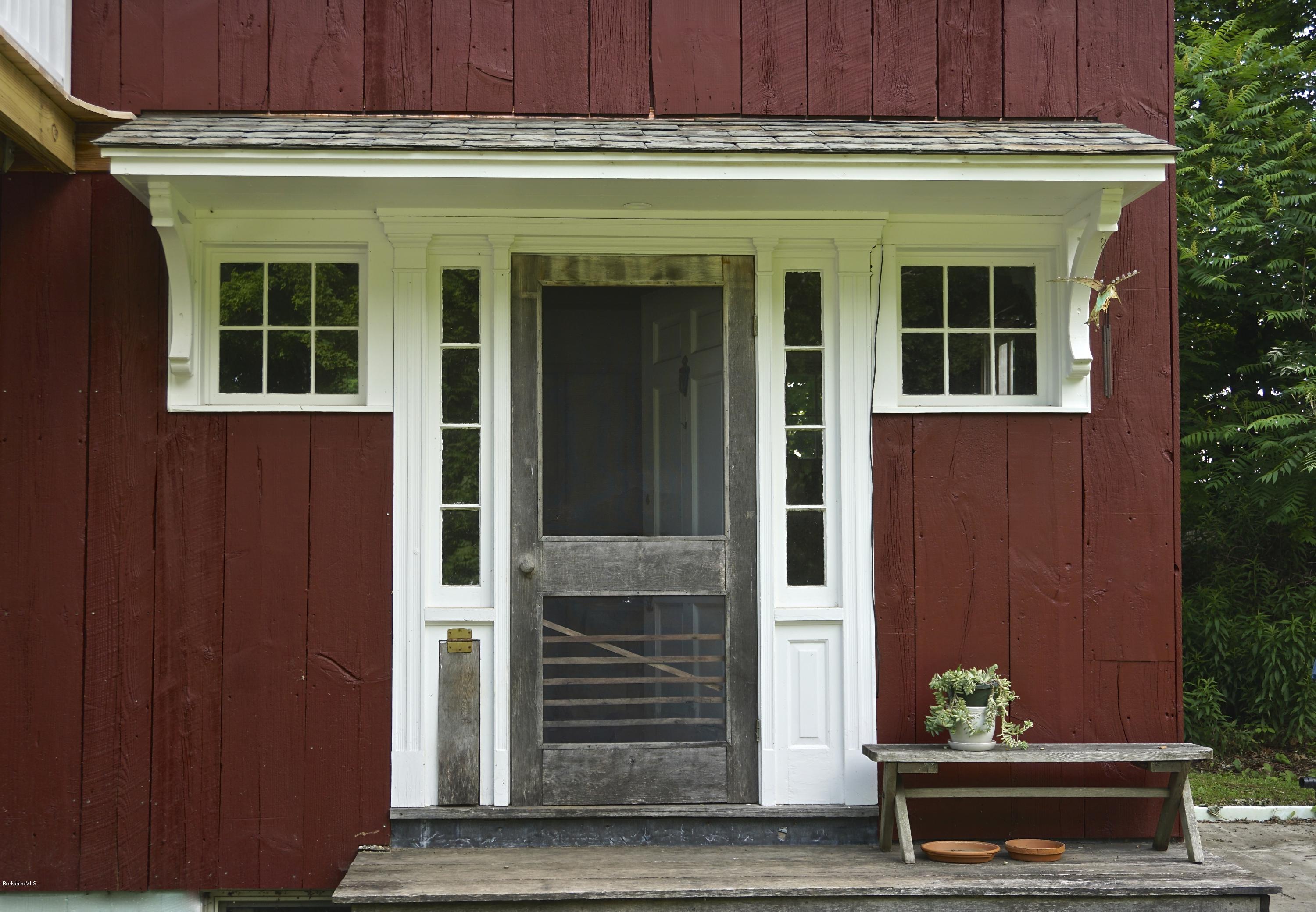 519 Main Road Monterey, MA 01245 - Photo 11 of 28 a front view of a house with a garden