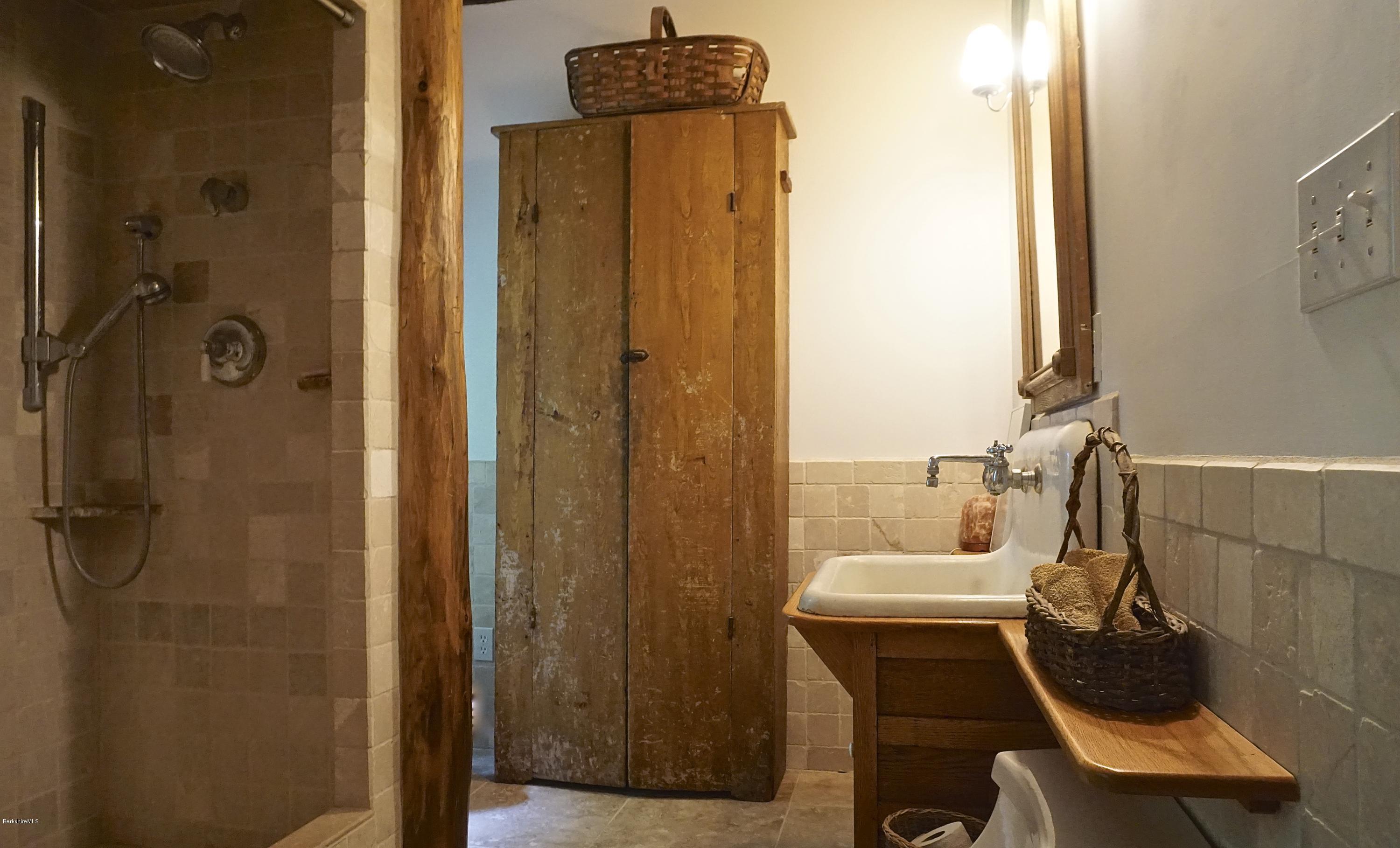 519 Main Road Monterey, MA 01245 - Photo 20 of 28 a bathroom with a sink a mirror a toilet and shower